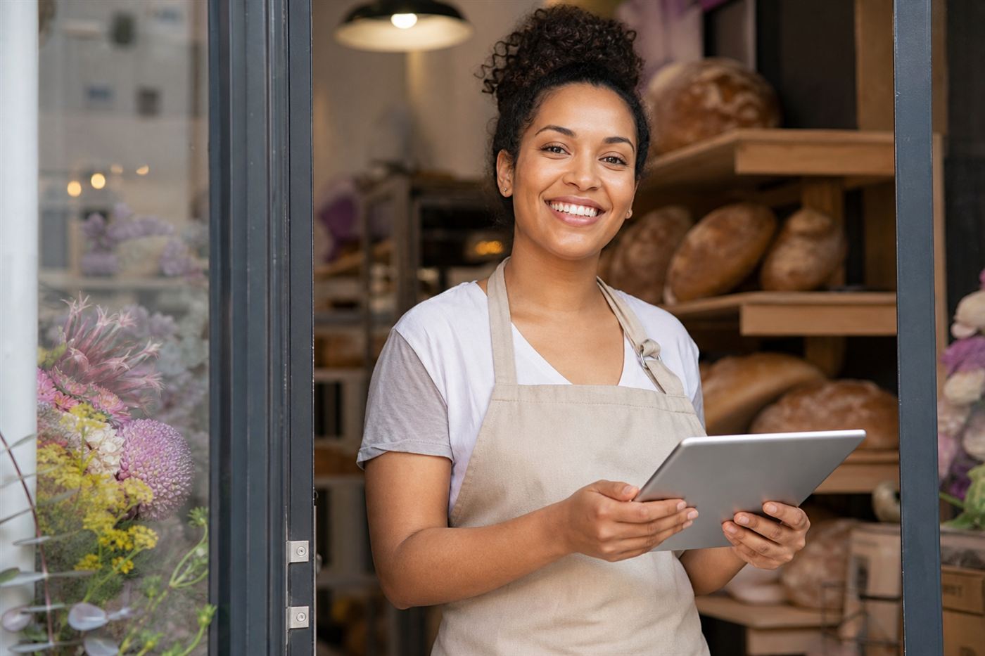 Smiling baker opening her new bakery with a website built by AI